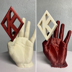 May include: A 3D-printed sculpture of a hand holding a diamond-shaped object. The hand is cream-colored, and the diamond is red. The diamond has a geometric design. The text "Yo, Nope!" is at the base of the red hand.