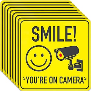 Pegatinas de seguridad con videovigilancia (18 x 18 cm) - Señales de "Estás en la cámara" con una sonrisa educada para evitar el allanamiento de propiedad privada.