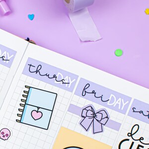 May include: A weekly planner with a grid layout and stickers. The stickers include a skull, a bow, a notebook, and the words "run errands". The planner has the days of the week labelled in purple.