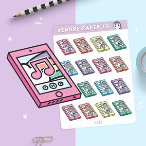 May include: A sheet of colorful phone stickers with a music note design. The stickers are in various colors, including pink, orange, yellow, and green. A large pink phone sticker is also present, with the same music note design. The text "DEMURE PAPER CO" is visible.