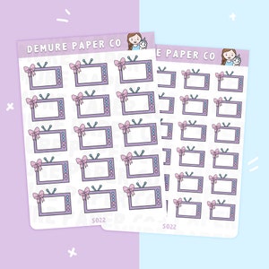 May include: A sheet of stickers featuring a repeating pattern of television sets with pink bows. The stickers are on a white background and have the text "DEMURE PAPER CO" and "S022" printed on them.