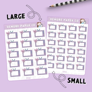May include: Two sheets of stickers featuring a television with a pink bow. The larger sheet has 16 stickers and the smaller sheet has 36 stickers. Both sheets have the text "DEMURE PAPER CO" and "S022".