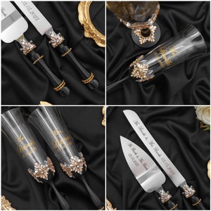 May include: A wedding cake cutting set with two black handled knives and two champagne flutes. The knives have gold accents and are engraved with the date "03.05.2023" and the names "Mr. Brooks & Mrs. Brooks". The champagne flutes are also engraved with the date and names, and have gold accents and rhinestones.
