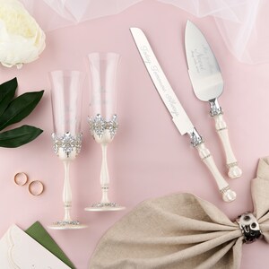 Silver wedding cake cutting set and engraved flutes for wedding ceremony