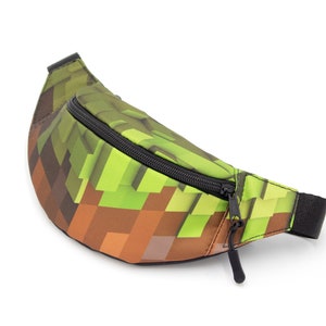 May include: A green and brown pixelated fanny pack with a black zipper and strap.