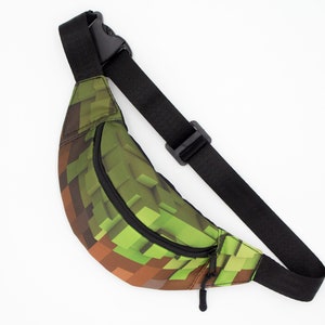 May include: A green and brown pixelated fanny pack with a black adjustable strap and zipper.