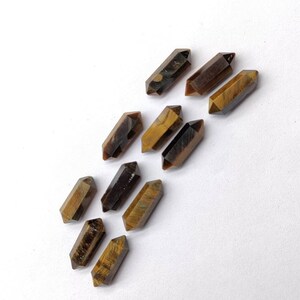 Natural Tiger Eye faceted pencil stones arranged together for jewelry making and gemstone crafts