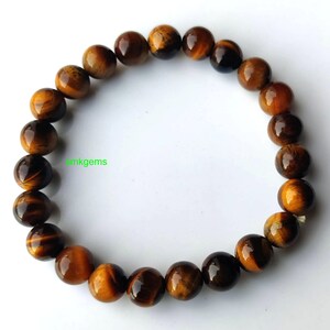 Handmade Tiger Eye stretch bracelet shown on hand