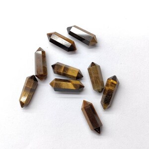 Side view of 5x16mm Tiger Eye pencil shape gemstones showing stone length and pointed shape