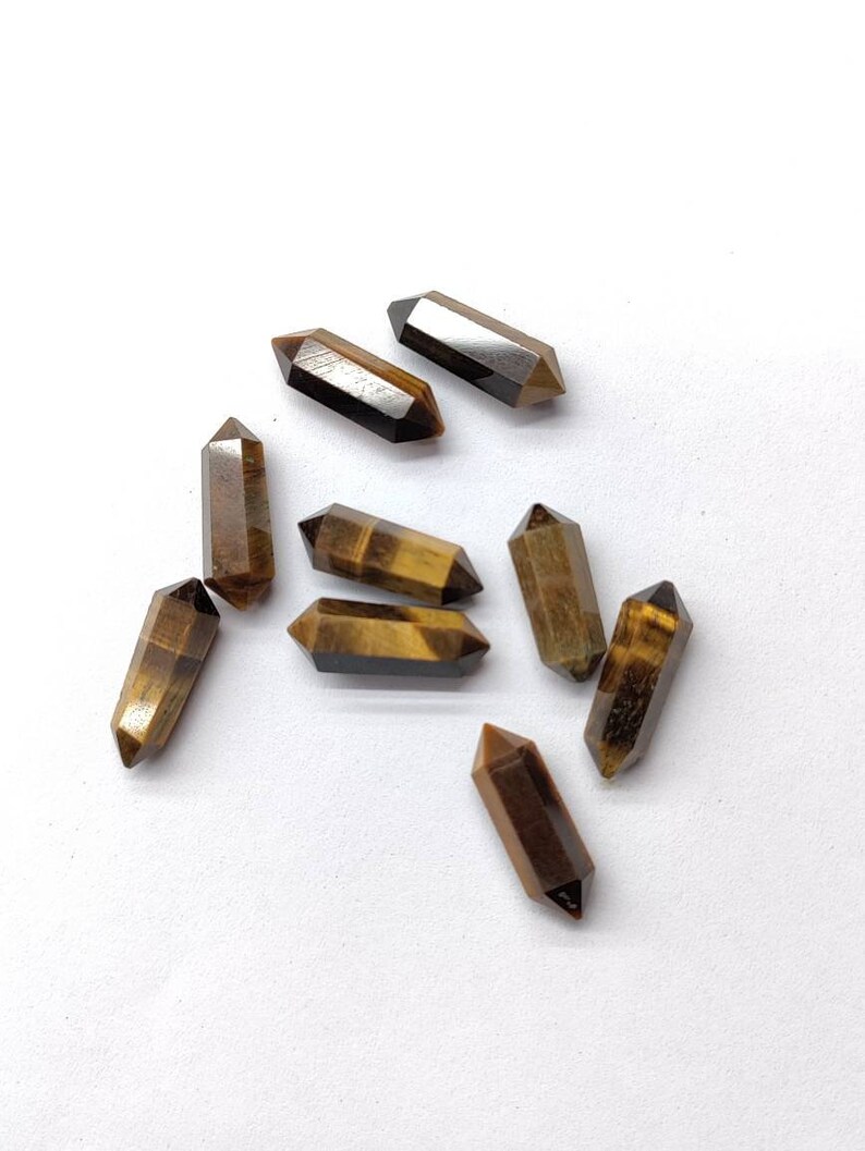 Side view of 5x16mm Tiger Eye pencil shape gemstones showing stone length and pointed shape