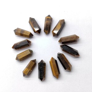 10 pieces of natural Tiger Eye pencil gemstones showing golden brown chatoyancy and faceted cut