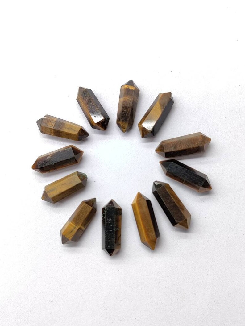 10 pieces of natural Tiger Eye pencil gemstones showing golden brown chatoyancy and faceted cut