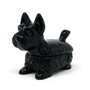May include: A black ceramic trinket box shaped like a Scottish terrier dog.