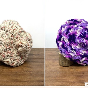 May include: Two crocheted berets, one white with red and brown flecks, and one purple with white and pink accents. Both berets have a textured, wavy design.