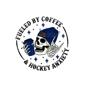May include: A black and white skull wearing a blue beanie with the word "Misfit" on it, holding a cup of coffee. The skull is surrounded by a circle with the text "Fueled by Coffee & Hockey Anxiety".
