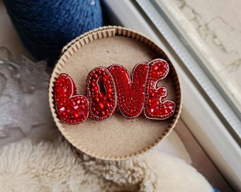 Red Beaded Brooch, Word, Name brooch