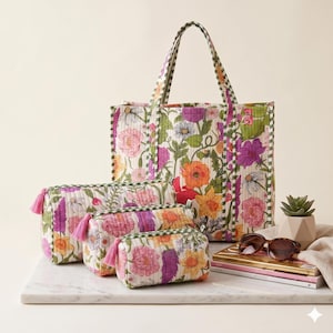 May include: A set of floral-patterned bags and accessories. The collection includes a large tote bag, three cosmetic bags with pink tassels, and a pair of sunglasses. The bags feature a colorful floral print with green and white accents.