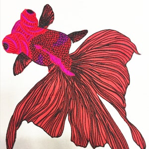 May include: Red embroidered goldfish applique with black outline and pink details. The fish has a large tail fin and is perfect for adding a touch of whimsy to clothing, bags, or home decor.