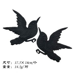 May include: Two black embroidered hummingbird patches. Each patch measures 17.5 x 18 cm.