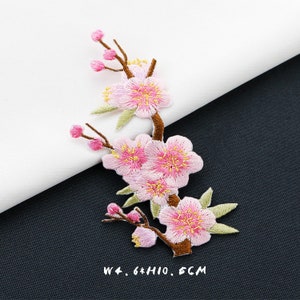 May include: Pink embroidered flower patch with green leaves and brown stems. The patch is 6 inches wide and 10 inches high. W: 6*H: 10. 5CM