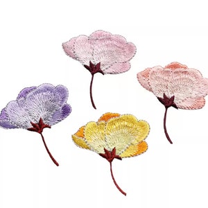 May include: Four embroidered flower patches in pink, purple, yellow, and orange. The flowers are stylised and have a simple stem.