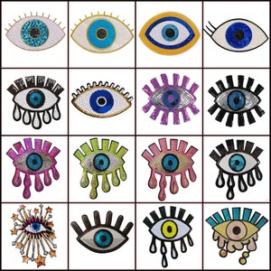 May include: Assortment of colorful eye-shaped patches with sequins and beads. The patches feature various designs, including a classic evil eye, a teardrop eye, and a starburst eye.