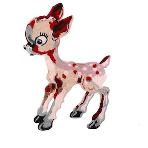 May include: A pink and red embroidered fawn with white spots. The fawn is standing on all four legs with its head turned to the left. The fawn has a black nose and black eyes.