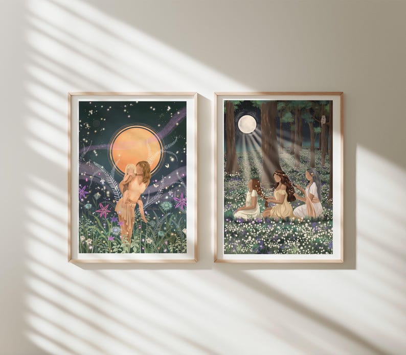 May include: Two framed art prints. One features a woman in a field with a large orange moon and starry sky. The other depicts three women in a forest with a full moon and sunlight. Both prints have a whimsical, ethereal theme.