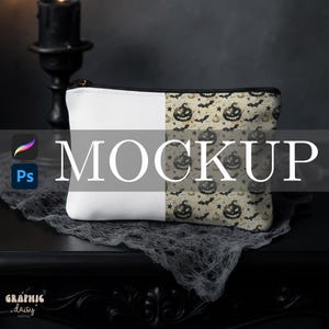 May include: A white and patterned Halloween-themed makeup bag. The bag is half white and half beige with a repeating pattern of jack-o'-lanterns and bats. The word "MOCKUP" is overlaid on the bag. The bag has a black zipper.