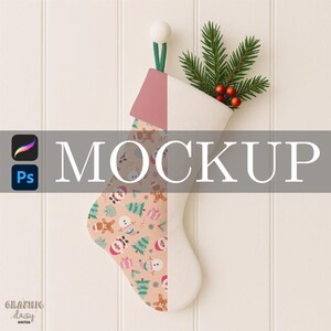 May include: A Christmas stocking mockup with a festive pattern featuring snowmen, gingerbread men, and gifts. The stocking is half-filled with greenery and red berries. The word "MOCKUP" is displayed across the image.