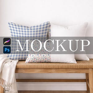 May include: A mockup featuring three decorative pillows on a woven bench. One pillow has a blue and white gingham pattern, another has a floral design, and the third is solid white. The word "MOCKUP" is displayed across the image.