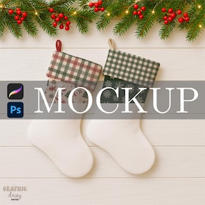 May include: Two white Christmas stockings with patterned tops, one red and green plaid, the other green and white checkered. Festive greenery with red berries and lights adorns the top, creating a holiday theme.