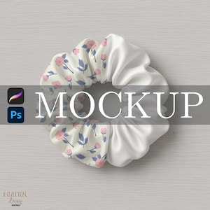 May include: A white and floral scrunchie with pink flowers and blue leaves. The scrunchie is half white satin and half patterned fabric. The word "MOCKUP" is displayed in large white letters across the image.