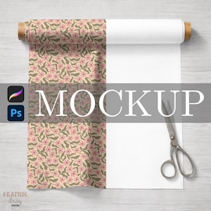 May include: A roll of fabric with a floral pattern featuring pink flowers and green leaves on a beige background. The word "MOCKUP" is displayed in large, gray letters. A pair of scissors is on the right side of the image.