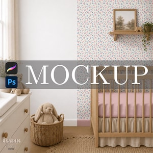 May include: A wooden crib with a pink sheet and a ruffled skirt, positioned next to a white dresser with a beige plush rabbit in a woven basket. A wooden shelf above holds a framed landscape print and a small potted plant against floral wallpaper.