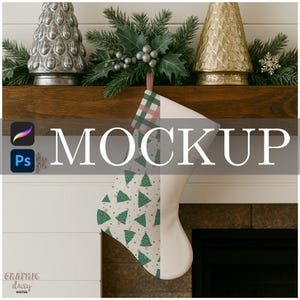 May include: A Christmas stocking with a green tree pattern and a red and green plaid cuff hangs from a wooden mantel. The word "MOCKUP" is displayed in large white letters. Decorative silver and gold Christmas trees are on the mantel.