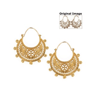 May include: A pair of gold hoop earrings with a delicate, intricate design. The earrings are made of a filigree pattern and have a crescent moon shape.