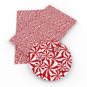 May include: Red and white peppermint swirl patterned paper. The paper is in a sheet and a circle shape.