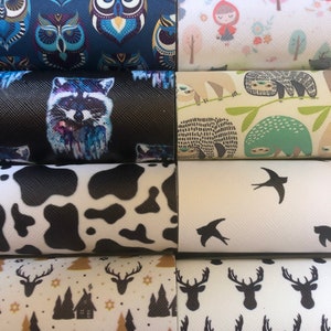 May include: A collection of eight fabric swatches with different patterns. The patterns include owls, raccoons, cows, deer, sloths, birds, and a woodland scene. The fabrics are all white with different colored patterns.