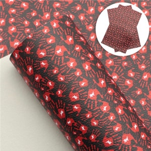 May include: Red and black faux leather sheet with a repeating pattern of white handprints. The sheet is rolled up and the pattern is visible on the outside of the roll.
