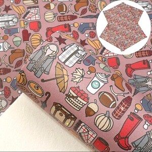 May include: A pink and brown patterned fabric with a variety of autumn-themed illustrations, including pumpkins, leaves, boots, and coffee cups.