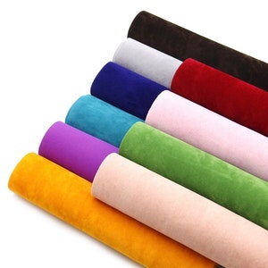 May include: A set of ten rolls of faux suede fabric in various colours, including brown, grey, red, blue, teal, purple, green, pink, and yellow.