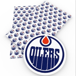May include: White fabric with a repeating pattern of the Edmonton Oilers logo in blue, orange, and white. A close-up shows the team's logo with the word "OILERS" in blue, a white background, and an orange oil drop.