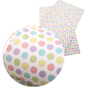 May include: Two sheets of white fabric with a polka dot pattern. The dots are in pastel colours, including pink, blue, green, and purple. The dots on one sheet have a white outline.