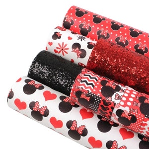 May include: A set of five red and black faux leather sheets with a Minnie Mouse theme. The sheets feature different patterns including polka dots, hearts, and glitter.