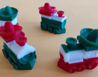 May include: Four miniature toy train engines painted in the colors of the Mexican flag, each with a green, white, and red stripe and a sombrero on top.