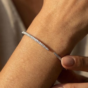 May include: A rustic wooden sign with the text "Welcome to our home" in white lettering. The sign has a distressed finish and a simple, inviting design, ideal for entryway decor.