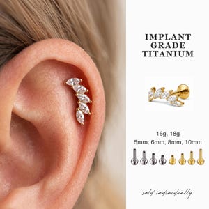 May include: Gold-tone ear cartilage stud featuring five marquise-cut clear stones in a curved arrangement. Text reads IMPLANT GRADE TITANIUM, 16g, 18g, 5mm, 6mm, 8mm, 10mm. Includes various post lengths and colors in silver and gold tones.