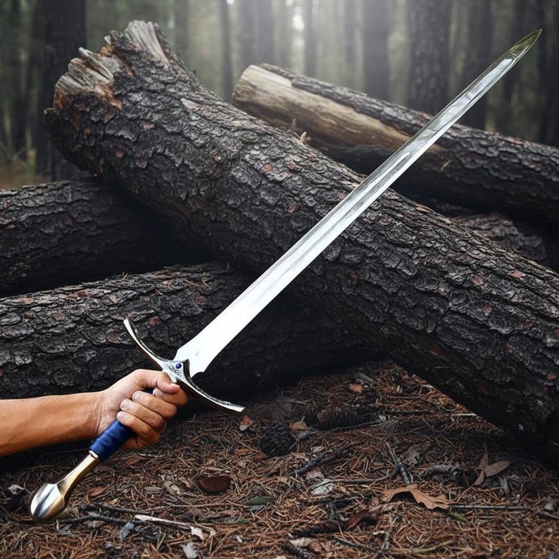 May include: A long, double-edged steel sword featuring a pointed blade, a silver-toned crossguard with a small blue circular inlay, and a dark blue wrapped handle ending in a smooth, rounded metallic pommel with a polished finish.
