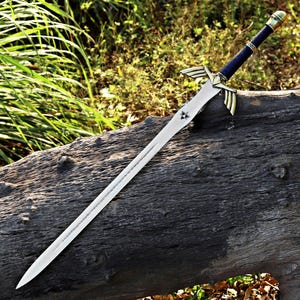 May include: A metal sword featuring a silver blade with a small triangular emblem near the hilt, a gold-colored crossguard with wing-like extensions, and a dark blue wrapped handle ending in a rounded gold-colored pommel cap.